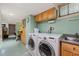 Well-lit laundry area featuring modern washer and dryer set and a convenient utility sink at 612 Swift Ave, Durham, NC 27701