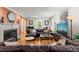 Inviting living room with hardwood floors, fireplace, and a plush leather sectional at 612 Swift Ave, Durham, NC 27701