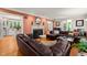 Cozy living room with a fireplace, hardwood floors, and leather sectional at 612 Swift Ave, Durham, NC 27701