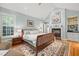 Light-filled main bedroom with a fireplace, hardwood floors and a neutral color palette at 612 Swift Ave, Durham, NC 27701