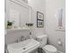 Powder room featuring a pedestal sink, artwork, and neutral paint at 612 Swift Ave, Durham, NC 27701