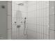 Walk-in shower featuring modern white tile and dual shower heads at 612 Swift Ave, Durham, NC 27701
