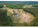 Aerial view of a community surrounded by greenery with home construction underway at 66 Sanders Farm Dr, Smithfield, NC 27577