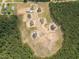 Aerial view of homesites under construction amid lush green scenery at 66 Sanders Farm Dr, Smithfield, NC 27577
