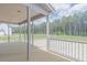 View of the back porch with wood flooring overlooking wooded yard at 66 Sanders Farm Dr, Smithfield, NC 27577