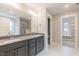 Bathroom with double vanity, stone countertops, tiled shower, and a bright, well-lit mirror at 66 Sanders Farm Dr, Smithfield, NC 27577