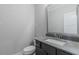 Stylish powder room featuring a modern vanity, gray countertop, and a sleek rectangular mirror at 66 Sanders Farm Dr, Smithfield, NC 27577