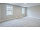 Bright bedroom with soft carpet, neutral walls, and two windows offering natural light at 66 Sanders Farm Dr, Smithfield, NC 27577