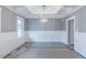 Elegant dining room featuring decorative wainscoting, coffered ceiling, and modern chandelier at 66 Sanders Farm Dr, Smithfield, NC 27577