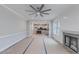 Open-concept living room showcasing a fireplace, view of the kitchen, and a modern ceiling fan at 66 Sanders Farm Dr, Smithfield, NC 27577