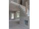 View of staircase and future living room with wainscotting and glass doors to the patio at 66 Sanders Farm Dr, Smithfield, NC 27577