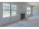 Living room with shiplap and fireplace with many windows allowing for natural light at 66 Sanders Farm Dr, Smithfield, NC 27577