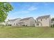 Exterior of a two-story home showcases the backyard, green grass, and light vinyl siding at 69 Curling Creek Dr # I286, Clayton, NC 27527
