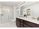 Bathroom with double vanity, granite countertop, and walk-in shower with glass doors at 69 Curling Creek Dr # I286, Clayton, NC 27527
