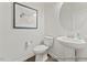 Powder room with pedestal sink, round mirror, and stylish decor at 69 Curling Creek Dr # I286, Clayton, NC 27527