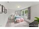 Bedroom features neutral carpet, natural light, and colorful decor accents at 69 Curling Creek Dr # I286, Clayton, NC 27527