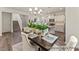 Bright dining area next to an open kitchen featuring pendant lighting and modern finishes at 69 Curling Creek Dr # I286, Clayton, NC 27527