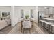 Elegant dining area with stylish table setting, modern decor, and gray kitchen cabinets at 69 Curling Creek Dr # I286, Clayton, NC 27527