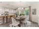 Elegant dining area with modern lighting and an open view to the kitchen, ideal for Gathering meals at 69 Curling Creek Dr # I286, Clayton, NC 27527