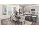 Elegant dining area with stylish table setting, modern decor, and gray kitchen cabinets at 69 Curling Creek Dr # I286, Clayton, NC 27527