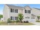 Charming two-story home featuring a two-car garage, black shutters, and well-maintained landscaping at 69 Curling Creek Dr # I286, Clayton, NC 27527