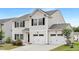 Charming two-story home featuring a two-car garage, black shutters, and well-maintained landscaping at 69 Curling Creek Dr # I286, Clayton, NC 27527