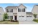 Charming two-story home featuring a two-car garage, black shutters, and well-maintained landscaping at 69 Curling Creek Dr # I286, Clayton, NC 27527