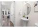 Clean half bathroom featuring a pedestal sink, oval mirror, and modern fixtures at 69 Curling Creek Dr # I286, Clayton, NC 27527