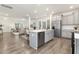 Modern kitchen with gray cabinets, stainless steel appliances, and an island open to the living room at 69 Curling Creek Dr # I286, Clayton, NC 27527