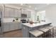 Modern kitchen with gray cabinets, stainless steel appliances, island with seating, and stylish backsplash at 69 Curling Creek Dr # I286, Clayton, NC 27527