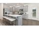 Modern kitchen with gray cabinets, stainless steel appliances, island with seating, and stylish backsplash at 69 Curling Creek Dr # I286, Clayton, NC 27527