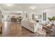 Open-concept living space seamlessly connecting the kitchen, dining, and living areas with hardwood floors at 69 Curling Creek Dr # I286, Clayton, NC 27527