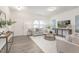 Bright living room featuring a gray sofa, round coffee table, and light gray wood-look flooring at 69 Curling Creek Dr # I286, Clayton, NC 27527