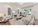 Bright living room featuring hardwood floors, a stylish entertainment center, and large windows at 69 Curling Creek Dr # I286, Clayton, NC 27527
