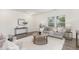 Inviting living room with a gray sofa, wood-look flooring, a round coffee table and natural light at 69 Curling Creek Dr # I286, Clayton, NC 27527