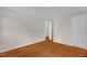 Spacious bedroom featuring a closet, light gray walls, white trim and beautiful hardwood floors at 714 W Mckinley St, Mebane, NC 27302
