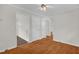Hallway view with hardwood floors, white walls, and doors at 714 W Mckinley St, Mebane, NC 27302