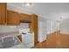Functional kitchen showcasing white appliances and wood cabinets at 714 W Mckinley St, Mebane, NC 27302