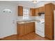 Charming kitchen featuring white appliances and wood cabinets at 714 W Mckinley St, Mebane, NC 27302