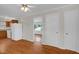 Sunlit living room view with hardwood floors, kitchen, and white walls at 714 W Mckinley St, Mebane, NC 27302