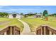 Expansive backyard featuring a covered parking area, a playground set, and a building with a covered entrance at 750 James Norris Rd, Angier, NC 27501