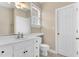 Bright bathroom with a white vanity, a large mirror, and a toilet at 750 James Norris Rd, Angier, NC 27501