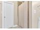 A bathroom featuring a tile surround shower with curtain and a white painted door at 750 James Norris Rd, Angier, NC 27501