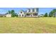 Well-maintained home with a sprawling front lawn under a bright, sunny sky at 750 James Norris Rd, Angier, NC 27501