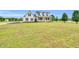 Expansive front yard with lush greenery surrounding a beautiful two-story home at 750 James Norris Rd, Angier, NC 27501