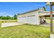 View of the three car garage on the side of the house with lawn and greenery at 750 James Norris Rd, Angier, NC 27501