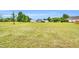A large grass lot with several trees and buildings spread throughout the yard at 750 James Norris Rd, Angier, NC 27501