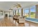 Bright sunroom with wood-look floors, neutral furniture, many windows, and ceiling fans at 750 James Norris Rd, Angier, NC 27501