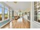 Bright sunroom with hardwood floors, multiple windows, and comfortable seating at 750 James Norris Rd, Angier, NC 27501