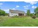 Spacious backyard with lush lawn, mature trees and a screened in porch at 7805 Tuscan Ridge Dr, Wendell, NC 27591